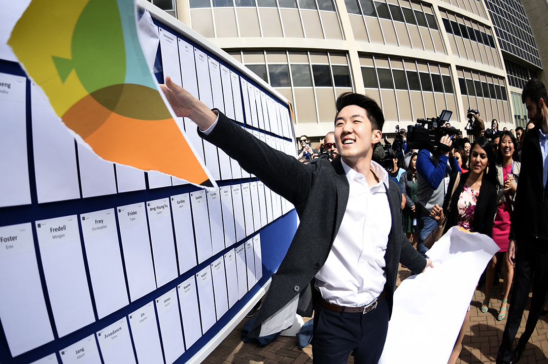 Class President Brian Park tears the wrap, revealing the match envelopes!